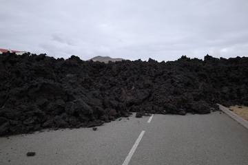 The solidified face of the slaggy lava that partially flooded Grindavík.