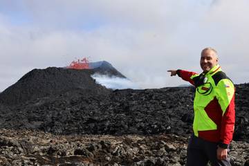 Lukáš Krmíček points to the southern wall of the volcanic cone, which shows signs of possible imminent collapse